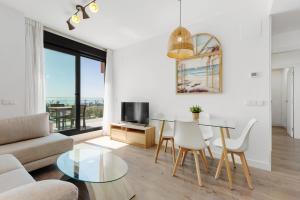 a living room with a table and a couch at Adhara 053 in Torre del Mar