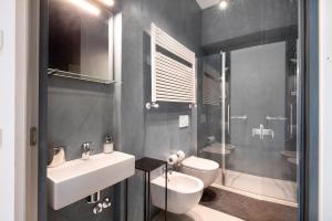 a bathroom with a sink and a toilet and a shower at Lierna amorevole dimora in Lecco in Lecco
