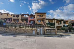 a row of houses on the side of a street at Residence Orizzonti app n 3 in Golfo Aranci
