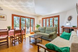 a living room with a couch and a table at Es Jaç in Cala Llombards