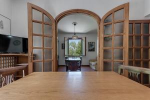 a dining room with a large table and glass doors at Gigli di Firenze in Rufina