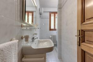 a white bathroom with a sink and a mirror at Gigli di Firenze in Rufina +15 photos