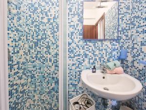 a bathroom with a sink and a shower with a mirror at Mono Le Lecce 25 b in Capoliveri +15 photos
