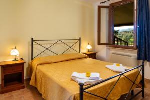 a bedroom with a bed with two towels on it at Capracotta - Sole in Montemassi +26 photos