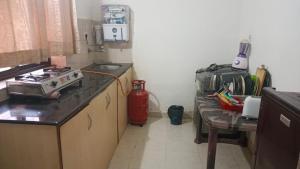 a kitchen with a stove and a counter top at 1 Bhk apartment kyle garden baga beech in Baga