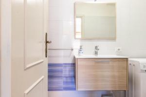 a bathroom with a sink and a mirror at Sea Shell Isola Rossa in Isola Rossa +16 photos