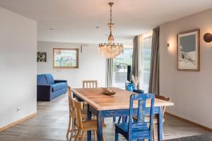 a dining room and living room with a wooden table and chairs at Aumia Apartment Saphir in Völs am Schlern