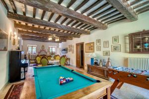 a pool table in a living room with ceilings at Castello di Magrano in Gubbio