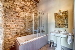 a bathroom with a bath tub and a sink and a shower at Castello di Magrano in Gubbio +37 photos
