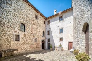 an alley between two large brick buildings at Castello di Magrano in Gubbio