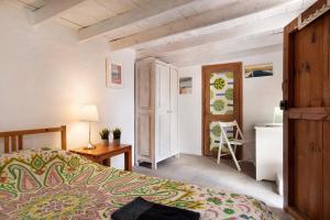 a bedroom with a bed and a table and a door at Aloe Art in Teguise
