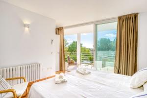 a bedroom with a bed and a large window at Casa Suca in Santa Ponsa +22 photos