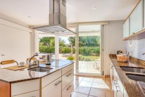 a kitchen with a sink and a large window at Casa Suca in Santa Ponsa