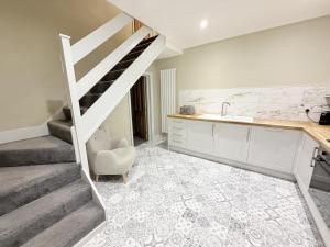 a kitchen with a staircase and a sink in a room at The Hideout in Southampton