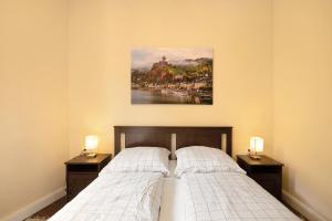 a bedroom with two beds and a painting on the wall at Alte Stadtvilla am Weinberg 1 in Traben-Trarbach