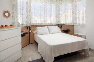 a bedroom with a white bed and a window at Torre del Mar Studio in Torre del Mar