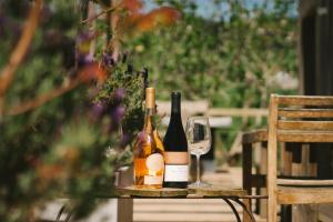 a table with bottles of wine and a glass at Quinta da Boa Esperança in Torres Vedras