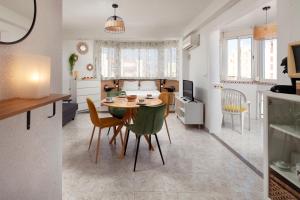 a kitchen and a living room with a table and chairs at Torre del Mar Studio in Torre del Mar