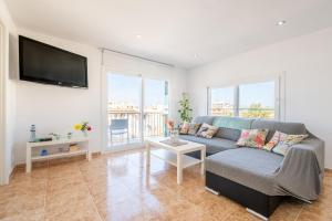 a living room with a couch and a flat screen tv at Wonderful in Can Picafort