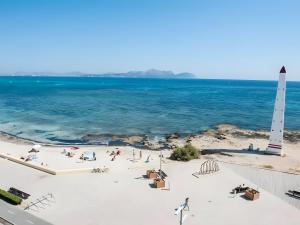 an aerial view of a beach with a lighthouse at Wonderful in Can Picafort