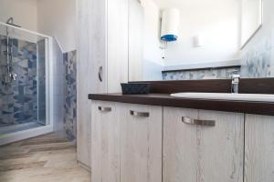 a bathroom with a sink and a counter top at Appartamento Blu in Dorgali +5 photos