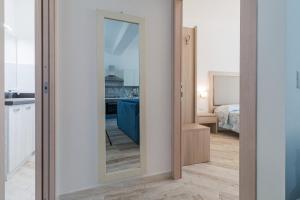 a mirror in a room with a bedroom at Appartamento Blu in Dorgali