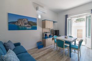 a living room with a blue couch and a table at Appartamento Blu in Dorgali
