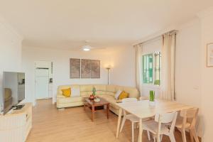 a living room with a couch and a table at A222 El Recreo in Torrox