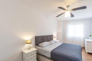 a bedroom with a bed and a ceiling fan at A222 El Recreo in Torrox