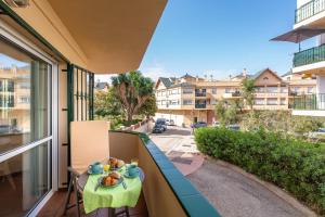 a table with food on a balcony with a view of a street at A222 El Recreo in Torrox