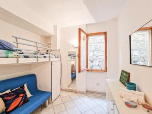 a small room with a blue chair and a desk at Bilo Le Lecce 15b in Capoliveri