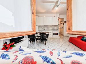 a kitchen and a living room with a bed in a room at Bilo Le Lecce 15b in Capoliveri +17 photos