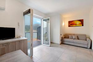 a living room with a couch and a television at Appartamento 7 Il Tornante in Nesso