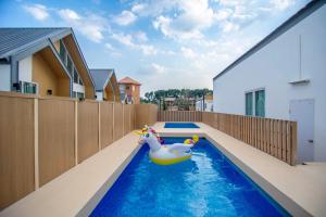 a swimming pool with a rubber duck in the middle of a house at Terra Sky Home in Pak Chong