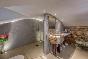 a bathroom with a sink and a shower with a mirror at Sa Cabana Vella Fornalutx in Fornalutx +23 photos