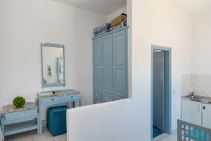 a bathroom with a blue cabinet and a mirror at Pico Bello Patmos 16 in Patmos