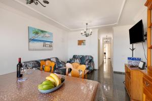 a living room with a table with a bowl of fruit on it at Casa Goro in Tazacorte
