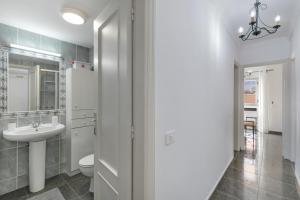 a bathroom with a sink and a toilet at Casa Goro in Tazacorte +24 photos