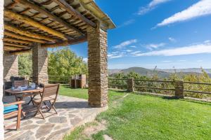 a patio with a table and chairs and a fence at Cortijo Jiménez in Pitres