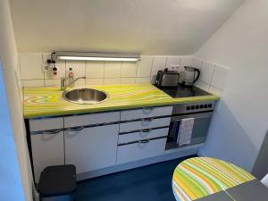 a small kitchen with a sink and a stove at room4rent in Lingen