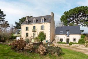 a large white house with a black roof at Le Penty - proche plages et centre in Concarneau