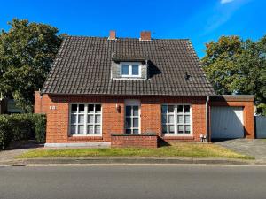 a red brick house with a window and a roof at room4rent in Lingen