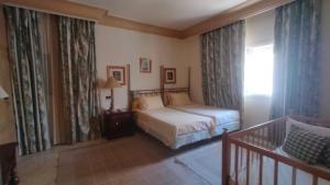 a bedroom with a bed and a window at Hurghada Beach House in Hurghada +11 photos
