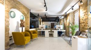a room with two desks and yellow chairs in a building at HOTEL FUENTE REDONDA LUXURY in Úbeda
