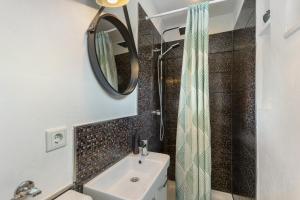 a bathroom with a sink and a mirror at Casa Verde Sauerland in Lennestadt +12 photos