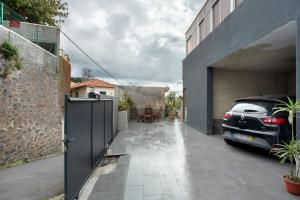 a car parked in a garage next to a building at Carros De Cesto Do Monte in Funchal