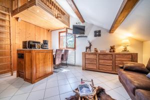 a living room with a couch and a table at Au Rêve Savoyard 6 - 4 personnes in Morillon +25 photos