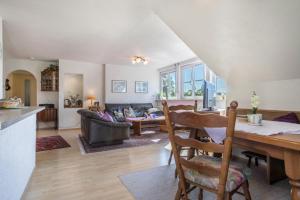 a kitchen and living room with a table and chairs at Annemarie und Walter Hechelmann in Lindau