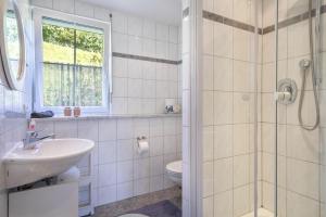 a bathroom with a toilet and a sink and a shower at Annemarie und Walter Hechelmann in Lindau +11 photos