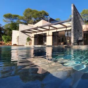 a swimming pool in front of a house at Villa Valériane in Trans-en-Provence